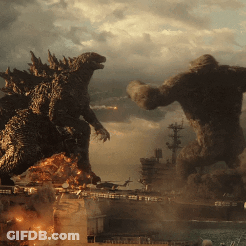 Two Giant Monsters Are Fighting Each Other In Front Of A Burning Ship GIF