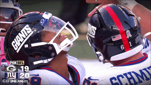 Two Giants Football Players Looking At Each Other GIF