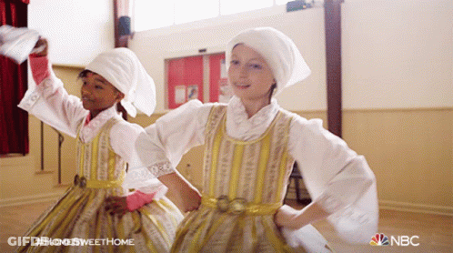Two Girls Are Dancing In A Room With A Nbc Logo On The Bottom GIF
