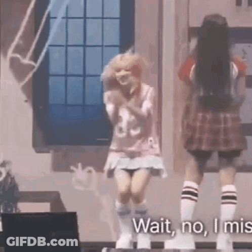 Two Girls Are Dancing On A Stage And One Of Them Is Wearing A Plaid Skirt And Socks . GIF