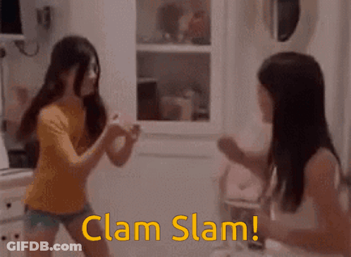 Two Girls Are Fighting In A Kitchen And The Words Clam Slam Are Visible GIF