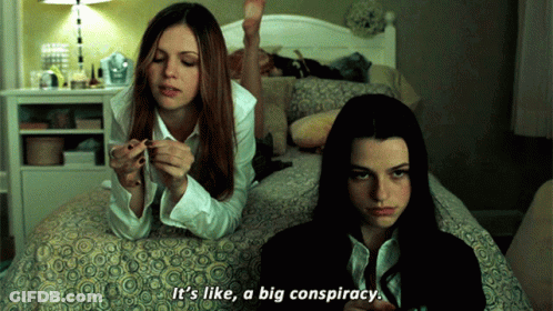 Two Girls Are Laying On A Bed And One Of Them Says It 'S Like A Big Conspiracy GIF