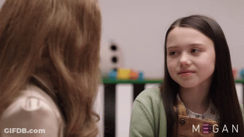 Two Girls Are Looking At Each Other With The Name Megan On The Bottom Right GIF