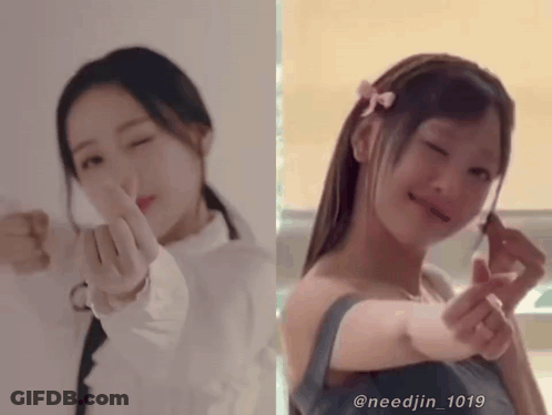 Two Girls Are Making A Heart Shape With Their Hands GIF