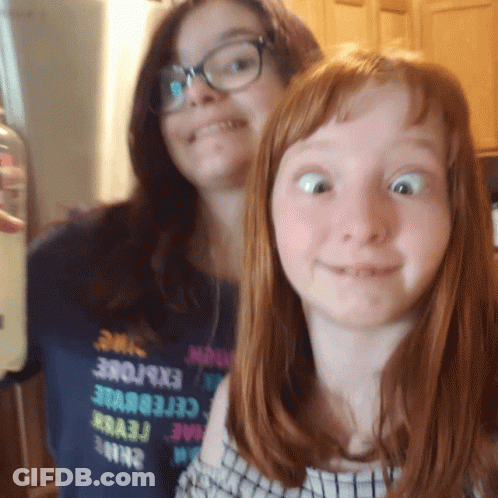 Two Girls Are Posing For A Picture And One Has A Shirt That Says Explore GIF