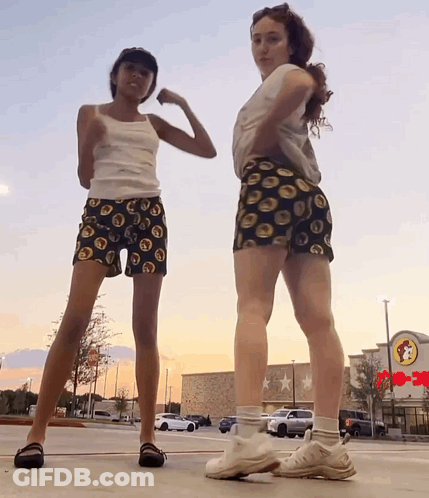 Two Girls Are Posing For A Picture In Front Of A Wendy 'S Restaurant GIF