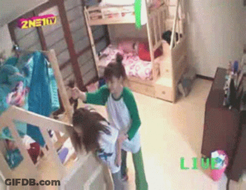 Two Girls Are Standing In A Room With Bunk Beds And A Sign That Says Znet Tv GIF