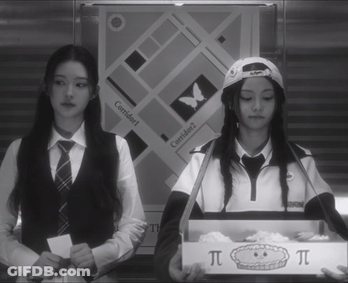 Two Girls Are Standing In Front Of A Sign That Says Corridor 1 GIF