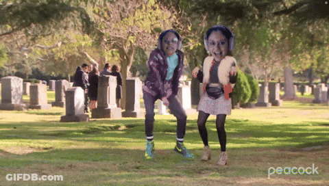 Two Girls Dancing In Cemetery With Peacock GIF