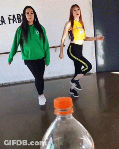 Two Girls Dancing In Front Of Lafab Sign GIF