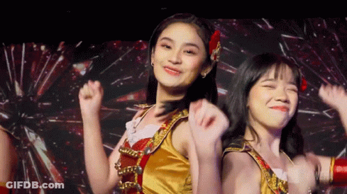 Two Girls Dancing On Stage, One In Gold GIF
