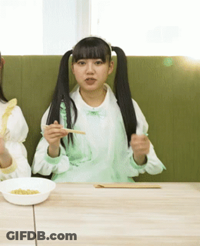 Two Girls Eating With Chopsticks GIF
