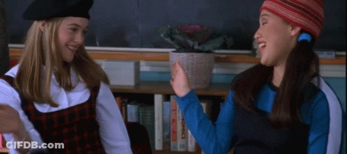 Two Girls High Five By Bookshelf GIF