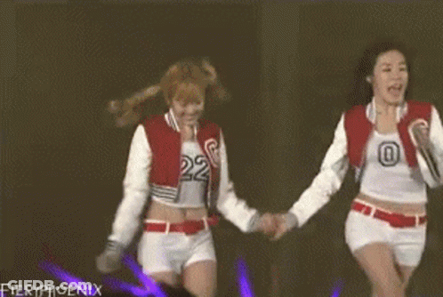 Two Girls Holding Hands On Stage With Fieryphoenix GIF