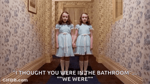 Two Girls In Blue Dresses In Hallway GIF