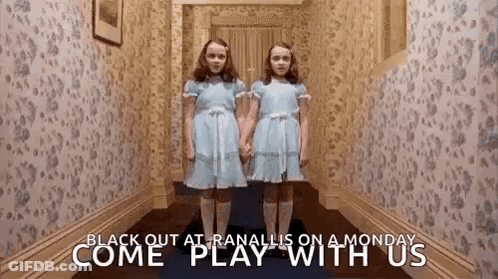 Two Girls In Blue Dresses In Hallway GIF