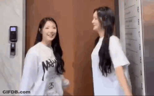 Two Girls In Front Of Door GIF