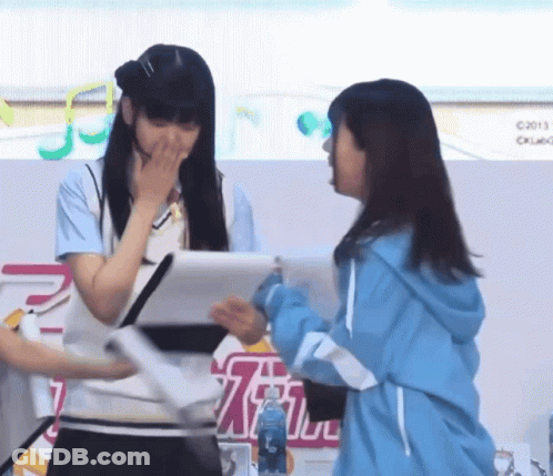 Two Girls In Front Of Sign Saying C2013 GIF
