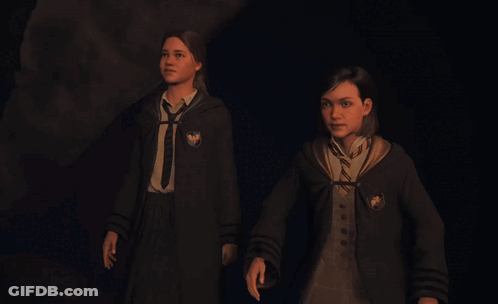 Two Girls In Harry Potter Uniforms Walking In Dark Room GIF