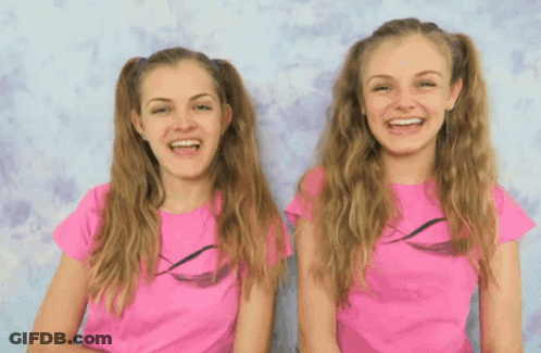 Two Girls In Pink Shirts Smiling GIF