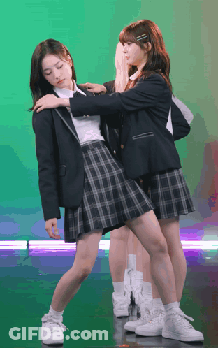 Two Girls In School Uniforms Are Posing For A Photo GIF