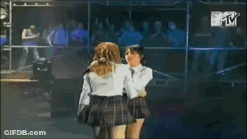 Two Girls In School Uniforms Hugging On Stage With MTV Logo GIF