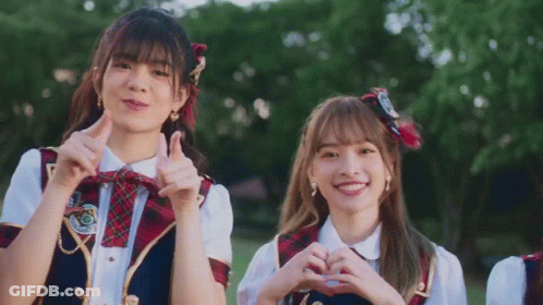 Two Girls In School Uniforms Making Heart Shape GIF