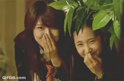 Two Girls Laughing Covering Mouths GIF