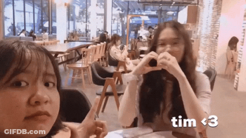 Two Girls Making Heart Shape With Hands Tim GIF