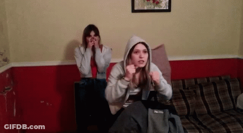 Two Girls On Couch One Wearing Hoodie GIF