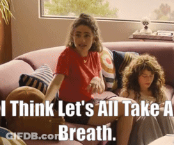 Two Girls On Couch Saying I Think Let's All Take A Breath GIF