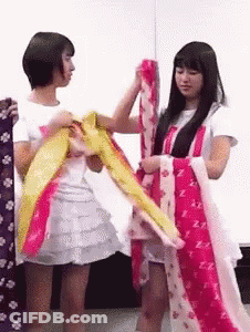 Two Girls One Holding Clothes In White Shirt Letter Z GIF