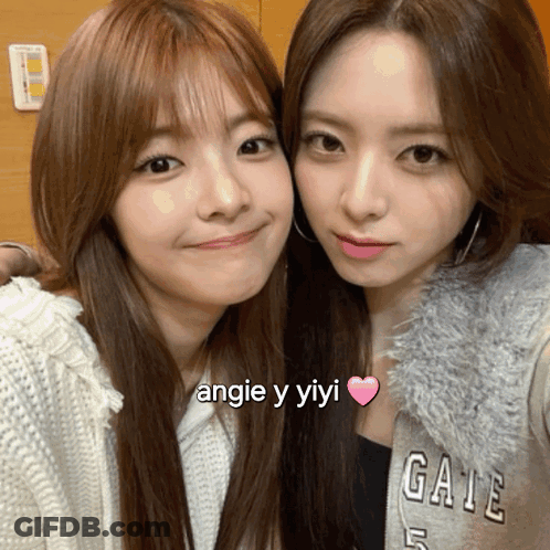 Two Girls Posing, One In Angie Y Yiyi Shirt GIF