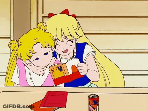 Two Girls Reading Book With Letter V GIF