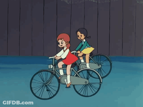 Two Girls Riding Bicycles GIF