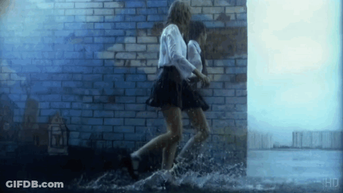 Two Girls Running Through Puddle GIF