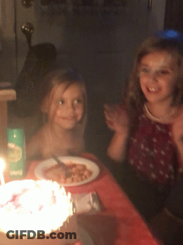 Two Girls Sitting At Table With Food And Living Box GIF