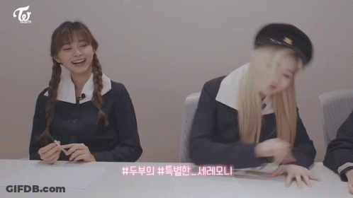 Two Girls Sitting At Table With Twice GIF