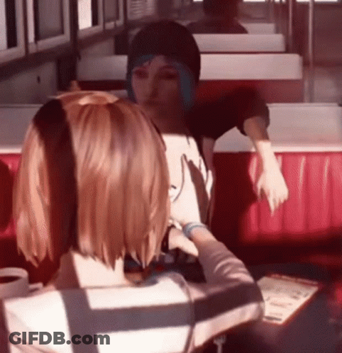 Two Girls Sitting In Diner Looking At Each Other GIF