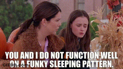 Two Girls Sitting In Pumpkin Patch One Talking To Other GIF