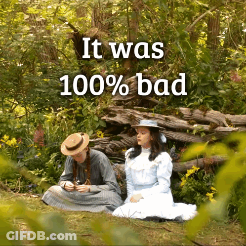 Two Girls Sitting In The Grass With The Words It Was 100 % Bad Below Them GIF
