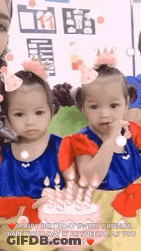 Two Girls Sitting Next To Birthday Cake GIF
