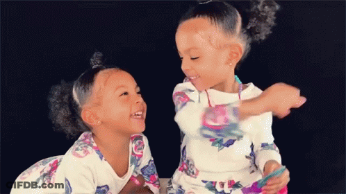 Two Girls Sitting Next To Each Other GIF