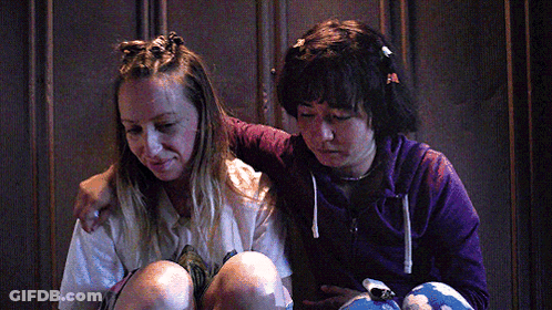 Two Girls Sitting Next To Each Other One In Purple Hoodie GIF