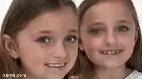 Two Girls Smiling For Photo GIF