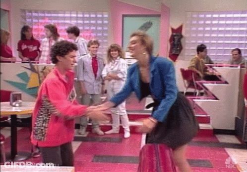 Two Girls Standing In Front Of Red Lockers GIF