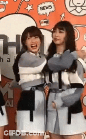 Two Girls Standing In Front Of Wall With News Speech Bubble GIF
