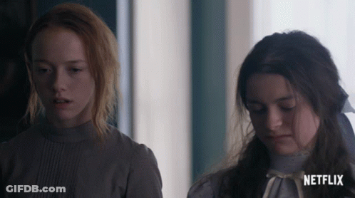 Two Girls Standing Next To Each Other With A Netflix Logo On The Bottom Right GIF