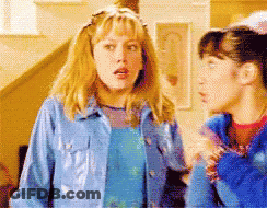 Two Girls Standing, One In Blue Jacket GIF