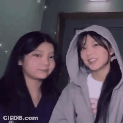 Two Girls Standing One In Hoodie GIF